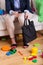 Working lady sitting on couch surrounded by clothes and toys