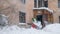 Working man is busy cleaning snow