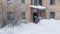 Working man is busy cleaning snow