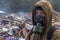 Working man in a gas mask on the background of burning debris. A lot of plastic bags thrown out on a dump. From plastic debris is