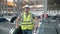 A working man in a rolled metal warehouse. A man in overalls and a protective helmet.