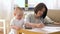 Working mother and baby playing with calculator