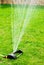A working portable lawn watering machine. Water jets for irrigation of plants