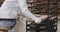 Working process in a big bakery man preparing the raw bred to be transported to baking in the industrial oven , food