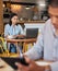 Working, reading and typing in a coffee shop with a digital worker writing an email on a computer. Job, career focus of