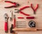 Working red tools on wooden background. Top view