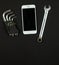 Working square concept, a set of tools and a smartphone on a black background, flat lay, copy space, top view