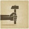 Working symbol hand with hammer old background