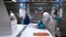 Working Team In A Seafood Processing Factory. Workers pack the fish in plastic.