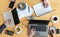 Working together on a joint business project, top view of the wooden table with hands, three laptops, papers, calculator and