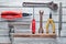 Working tool on a white wooden background: screwdriver, pliers, scrap, hammer, nippers, file, adjustable wrench. Top view.