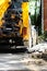 A working tractor pulls out the outrigger to create stability before excavating the soil in the event of a water pipe accident und