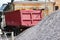 A working truck is preparing to unload gravel on the site to build a parking lot for tourist buses. The upper awning is