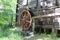 Working watermill wheel with falling water in the village