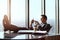 Working wirelessly. a handsome young businessman reading a text message while sitting in his office.