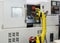 Working yellow robotic hand and CNC machine