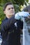 Workman Clearing Leaves From Guttering Of House