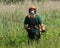 Workman clearing long grass and weeds