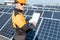 Workman examining electricity production of a solar power plant