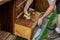 A workman fixing cabinet with screwdriver in kitchen