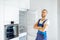 Workman installing fridge on the kitchen at home