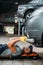 workman lying and working under car