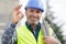 Workman making ok sign on unfocused background