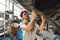 Workman mechanic working under car in auto repair shop