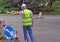 Workman pointing down toward road works