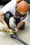 Workman pouring fuel in a chainsaw