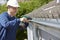 Workman Replacing Guttering On Exterior Of House