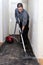 Workman vacuuming a passage during renovations