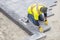 Workman in Yellow Safety Jacket Laying Patio Paver Stones 2