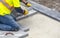 Workman in Yellow Safety Jacket Laying Patio Paver Stones 3