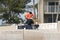 Workmen painting a keep off sign on a seawall.