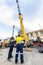 Workmen on site during the preparations to erect a large high rise industrial crane