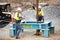 Workmen on site during the preparations to erect a large high rise industrial crane