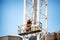 Workmen on site during the preparations to erect a large high rise industrial crane