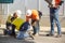 Workmen on site during the preparations to erect a large high rise industrial crane