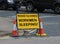 Workmen sleeping road closed sign warning public notice