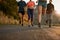 Workout buddies might be your secret to success. a fitness group running along a rural highway.