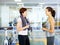 Workout buddies. Two girls talking and looking at each other in the gym.