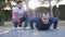 Workout with personal trainer outdoors. Fitness man doing super slow push-ups in a park as part of a workout routine