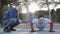 Workout with personal trainer outdoors. Fitness man doing super slow push-ups in a park as part of a workout routine