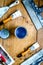 Workplace of builder with instruments and paint on wooden background top view