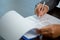 Workplace closeup person professional businesswoman sitting at desk hold pen signing or signature contract paper. Employee woman