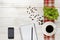 Workplace with cup of coffee, indoor plant, empty notebook and pencil on wooden surface