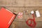 Workplace of doctor. Red stethoscope, clipboard and pills on wooden desk