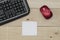 Workplace, keyboard mouse and notepaper on wood table