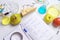 Workplace lab assistant top view. Food safety laboratory procedure, analysing fruits from the market. Notebook and blue pen on the